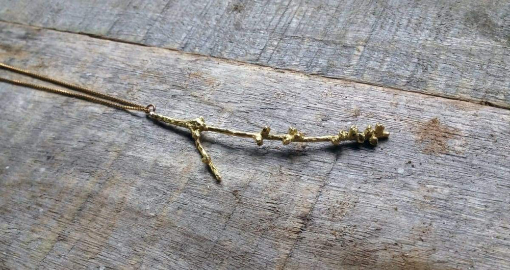 https://www.discovered.us/cdn/shop/products/real-branch-necklace-satin-gold-bras-long-chain-perfect-gift-special-person-nature-inspired-hand-made-forest-inspiration-twig-handmade-solorzano-discovered-926_1000x530.jpg?v=1673000720